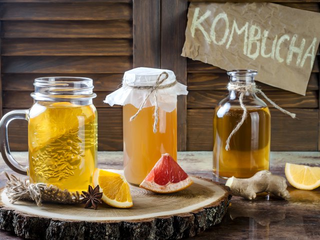 Homemade fermented raw kombucha tea with different flavorings. Healthy natural probiotic flavored drink.