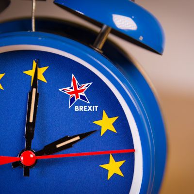 Alarm clock with the colors of the EU flag and one UK star. Representing the countdown for Brexit negociations and strategy concept between European Union and United Kingdom.