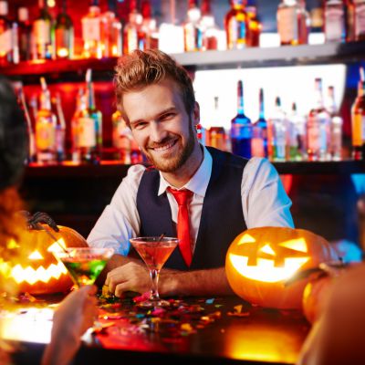 Young handsome bartender working at Halloween